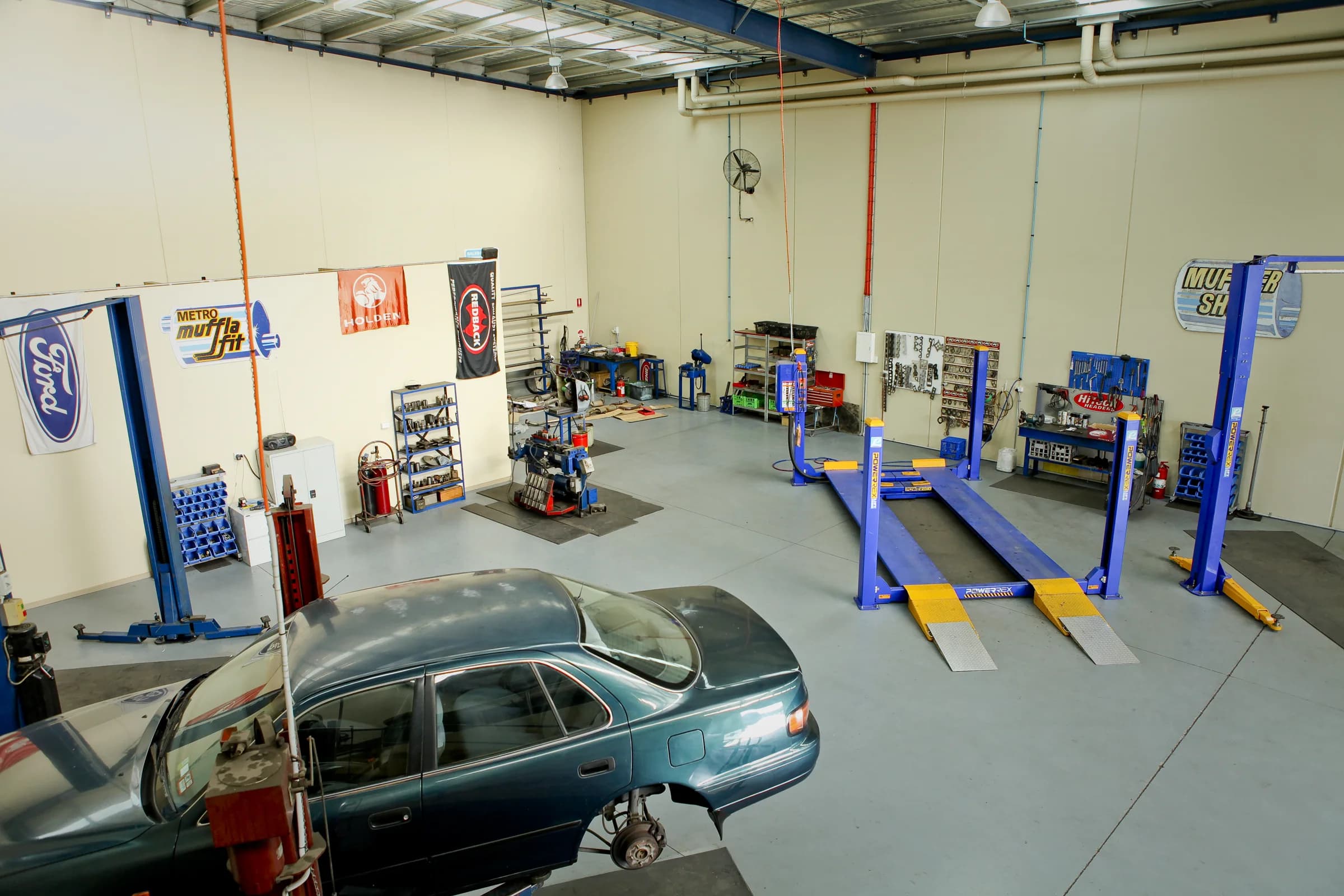 The ATR Automotive workshop with a car beside the vehicle hoists
