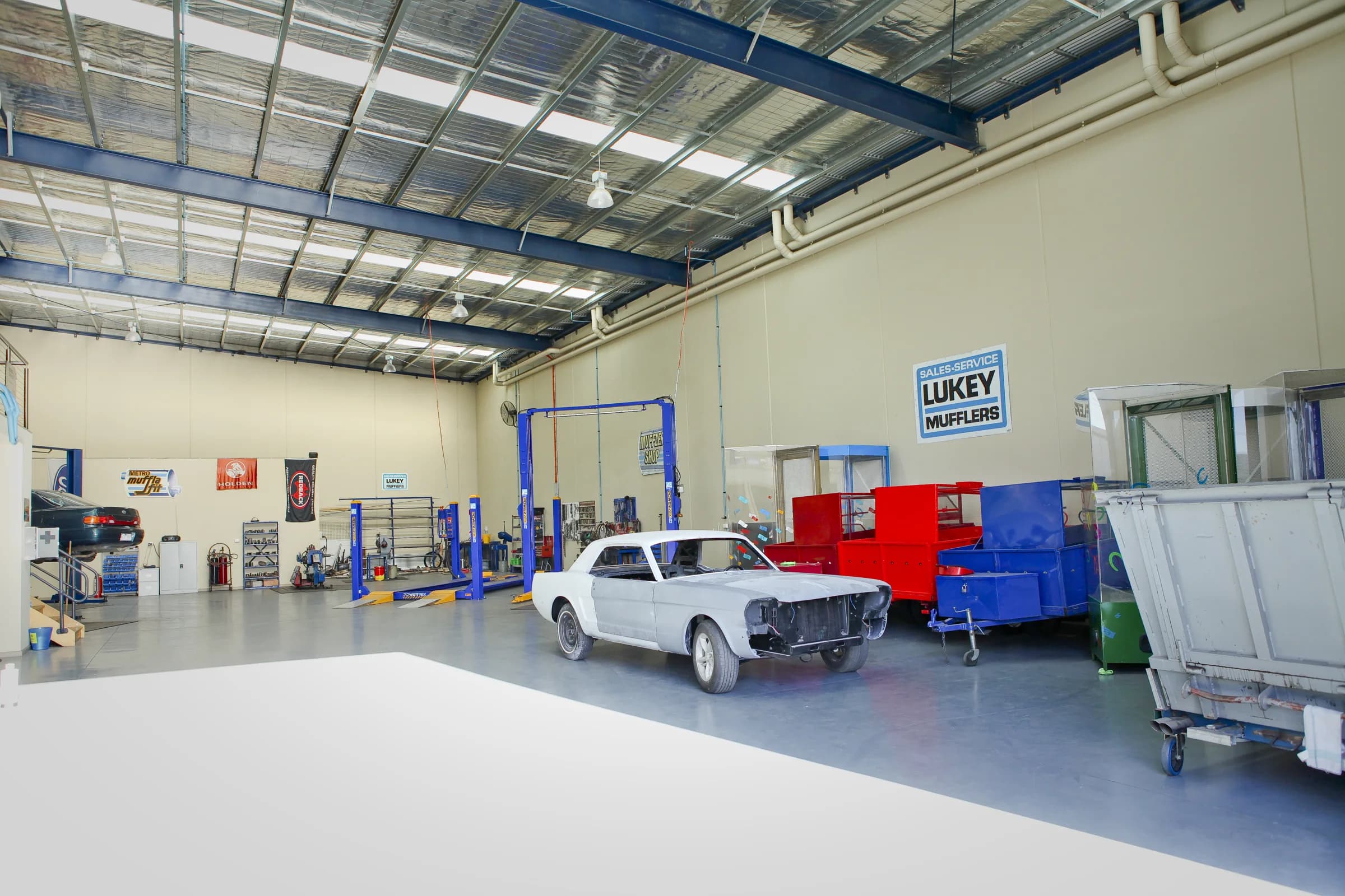 Vehicle hoists and a classic car inside ATR Automotive